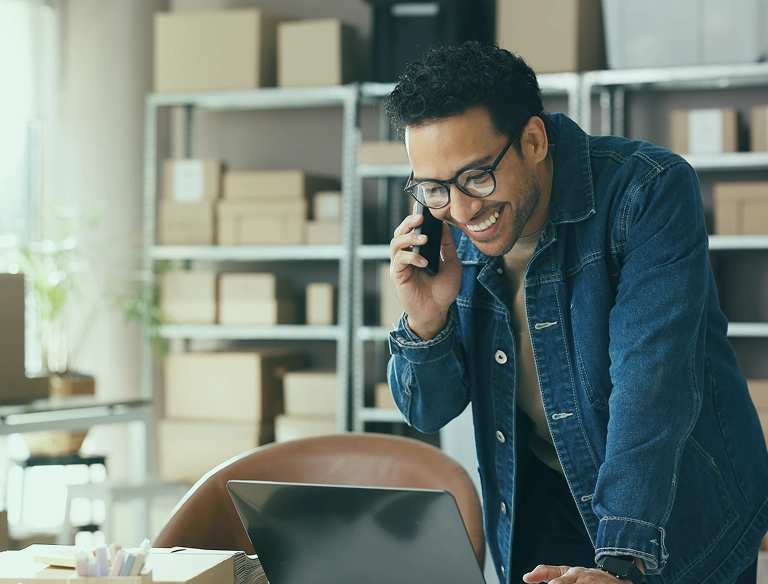 man with computer and phone